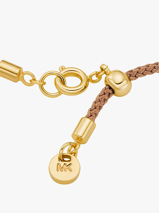 سوار مرصع بشعار الماركة ذهبي اللون michael kors سوار مرصع بشعار الماركة ذهبي اللون